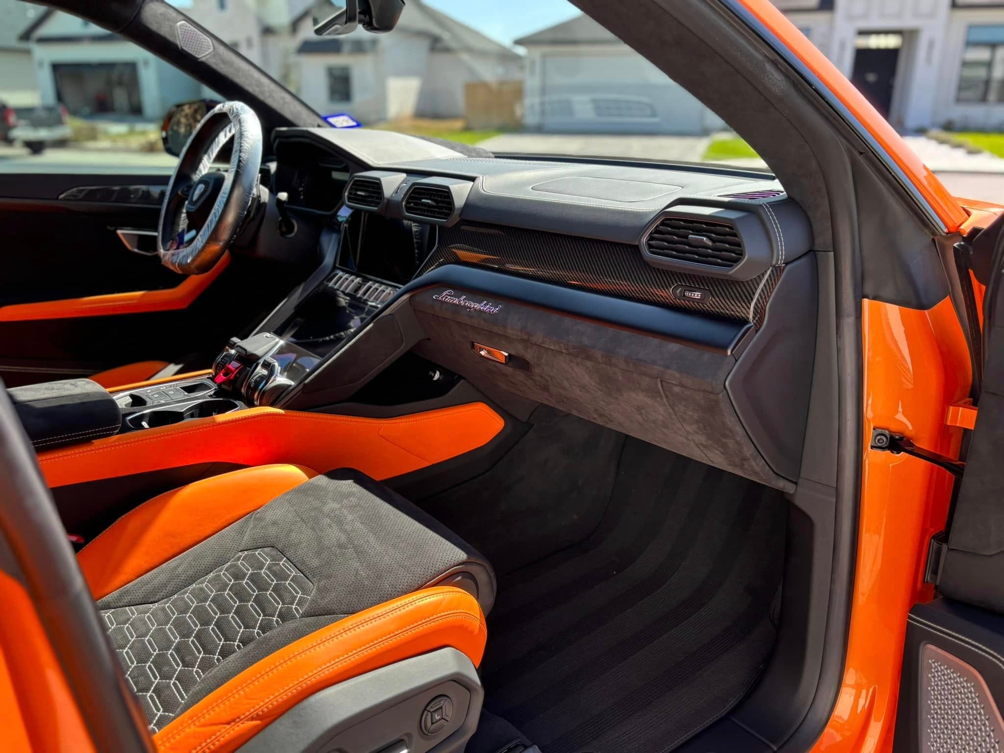 White Dodge Charger interior with red-accented leather seats, freshly cleaned