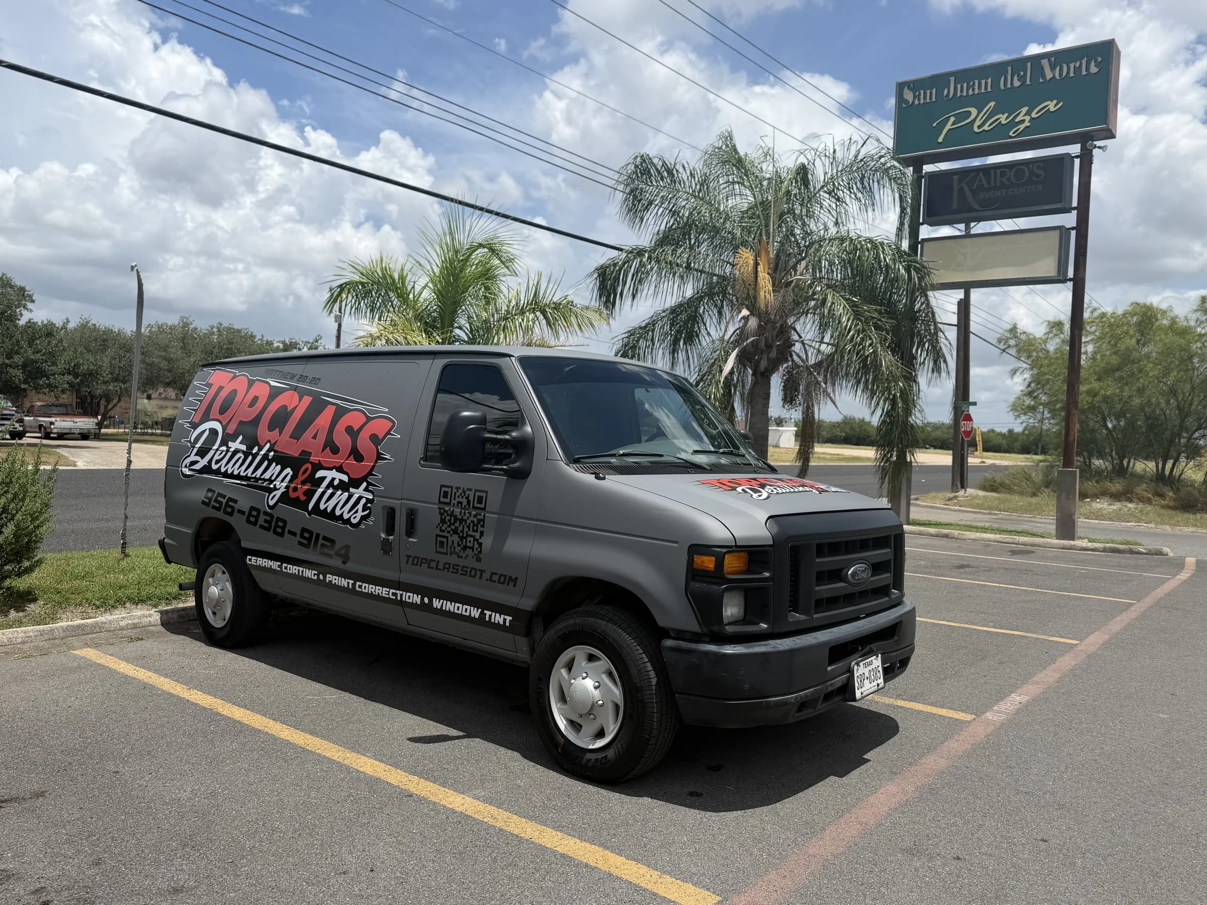 Top Class Detailing and Tints wrapped work van parked beside San Juan del Norte Plaza